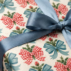 Vintage Christmas wrapping paper with red gingham bows and dusty blue satin ribbon by Wrapped Studios.