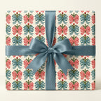 Vintage Christmas gift wrap with red gingham and blue bows, tied with blue satin ribbon by Wrapped Studios.