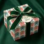 Vintage Christmas wrapping paper with a holiday bow pattern and green velvet ribbon by Wrapped Studios.