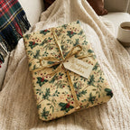 Wrapped Studios gift with vintage holly Christmas wrapping paper and a gold ribbon.