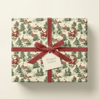 Vintage Christmas gift wrap with Santa & winter scene, tied with a velvet ribbon from Wrapped Studios.
