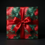 Elegant Christmas gift wrap featuring trees and red ribbon bow, Wrapped Studios.