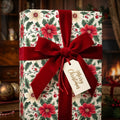 Christmas gift wrapped in elegant floral wrapping paper, tied with a luxurious red velvet ribbon.