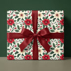 Elegant floral Christmas wrapping paper with red ribbon from Wrapped Studios.