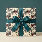 Square gift box wrapped in holly berry Christmas wrapping paper with teal ribbon from Wrapped Studios.
