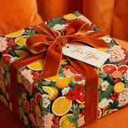 Elegant gift wrapped in floral citrus wrapping paper, finished with a velvet ribbon and "For You" tag.