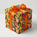 Elegant citrus floral wrapping paper with bright orange ribbon for birthday or any occasion gifts.