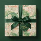 Vintage map wrapping paper with a luxury green ribbon and Wrapped Studios gift tag.