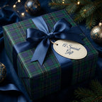 Elegant Christmas gift wrapped in plaid paper with a navy satin bow and "A Special Gift" tag.