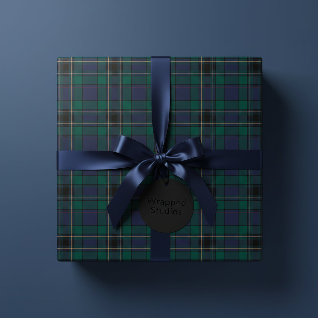 Square gift wrapped in green plaid paper with a navy ribbon and bow.