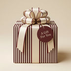 Elegant striped gift wrapped in luxury paper with satin bow and "A Gift For You" tag.