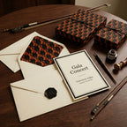 Musical violin wrapping paper on luxury gift boxes with gala invitations by Wrapped Studios.