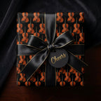 Elegant violin wrapping paper with a luxury black satin bow and cheers tag by Wrapped Studios.