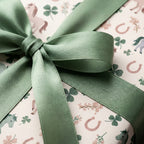 Equestrian horse and clover wrapping paper with a sage green satin bow from Wrapped Studios.