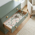 Horse and clover wrapping paper by Wrapped Studios lining a green dresser drawer.