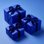 Elegant navy blue gift boxes wrapped in solid color paper with velvet ribbon for birthdays or special occasions.