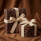 Coffee bean wrapping paper on gifts tied with cream ribbon bows for a caffeine lover's birthday present.