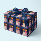 Birthday gift wrapped in cake pattern paper with a navy ribbon and bow.