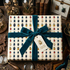 Elegant gift wrapped in insect-patterned paper with a teal velvet ribbon, ideal for curiosity-themed gifts.