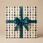 Gift wrapped in bug print wrapping paper with teal satin ribbon.