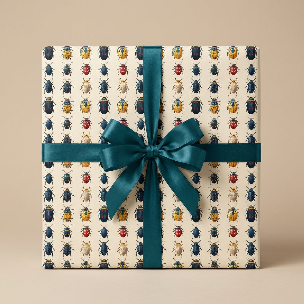 Gift wrapped in bug print wrapping paper with teal satin ribbon.