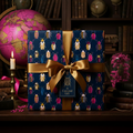 Elegant gift wrapped in navy blue beetle print wrapping paper, tied with a gold satin ribbon.