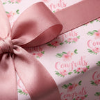 Elegant pink floral congratulations wrapping paper with a matching rose satin ribbon by Wrapped Studios.