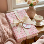 Pink floral congratulations wrapping paper with cream ribbon and gift tag by Wrapped Studios.