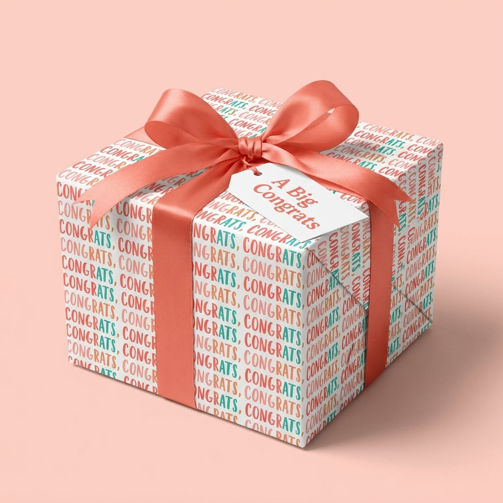Congratulations wrapping paper with a coral satin bow and gift tag by Wrapped Studios.