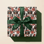 Black Santa Christmas wrapping paper with a green ribbon bow on a gift box, by Wrapped Studios.