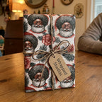 Retro Black Santa Christmas gift wrap tied with twine on a gift box, by Wrapped Studios.