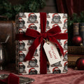 Cool Black Santa Christmas wrapping paper with a red velvet ribbon on a gift by Wrapped Studios.
