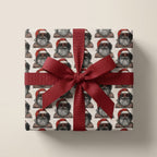 Cool Black Santa Christmas wrapping paper with a red ribbon bow on a gift box by Wrapped Studios.