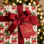 Holly and bow Christmas wrapping paper with red ribbon and 'No Peeking' tag by Wrapped Studios.
