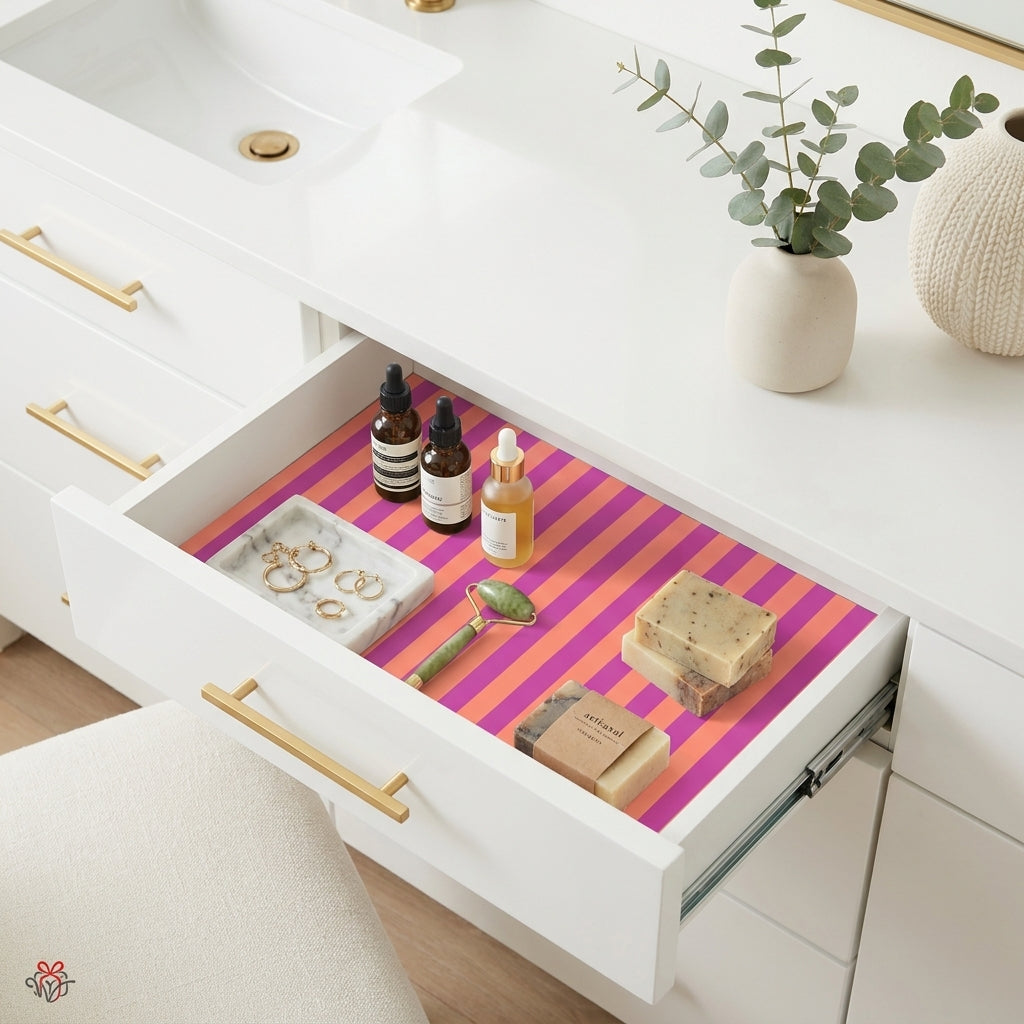 Vibrant pink and orange striped wrapping paper used as vanity drawer liner by Wrapped Studios.