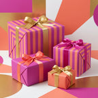 Modern pink and orange striped wrapping paper with satin bows by Wrapped Studios.