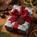 Western cowboy Santa wrapping paper in blue with a red ribbon by Wrapped Studios.