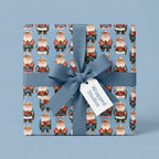 Cowboy Santa Christmas wrapping paper with a blue ribbon bow, by Wrapped Studios.