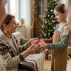 Girl giving grandmother a gift in vintage Christmas wrapping paper by Wrapped Studios.