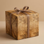Square gift wrapped in rustic brown wrapping paper with ribbon and bow.
