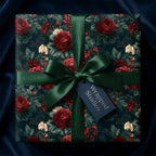 Luxury floral wrapping paper with red roses and green satin ribbon by Wrapped Studios.