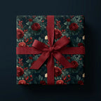 Luxury Christmas wrapping paper with red roses and a burgundy bow on a gift box by Wrapped Studios.