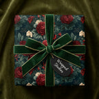 Luxury vintage floral wrapping paper with red roses and a green velvet bow by Wrapped Studios.