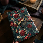 Luxury dark floral wrapping paper with red roses and gold twine by Wrapped Studios.