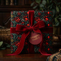 Elegant floral wrapping paper with a velvet red ribbon bow from Wrapped Studios.