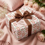 Cute monkey baby shower wrapping paper with a brown bow and pink roses by Wrapped Studios.