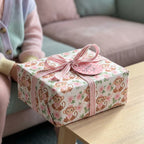 Cute monkey birthday wrapping paper with pink floral pattern and striped ribbon, by Wrapped Studios.