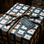 Cute polar bear holiday wrapping paper by Wrapped Studios, tied with a rustic twine bow and tag.