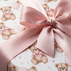 Teddy bear baby shower wrapping paper with a pink satin ribbon bow, by Wrapped Studios.