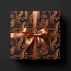 Geeky copper circuit board tech wrapping paper with a satin ribbon on a gift box by Wrapped Studios.